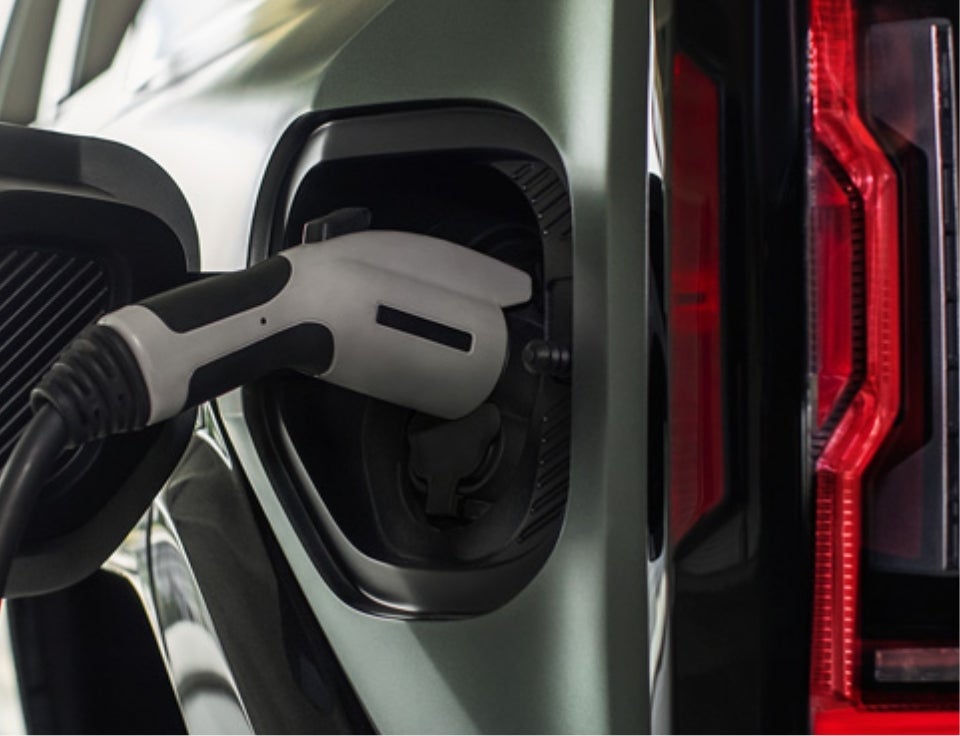 Close up of charging port with charger plugged in on a GMC Hummer EV SUV - Billy Lawrence GMC in ABBEVILLE AL